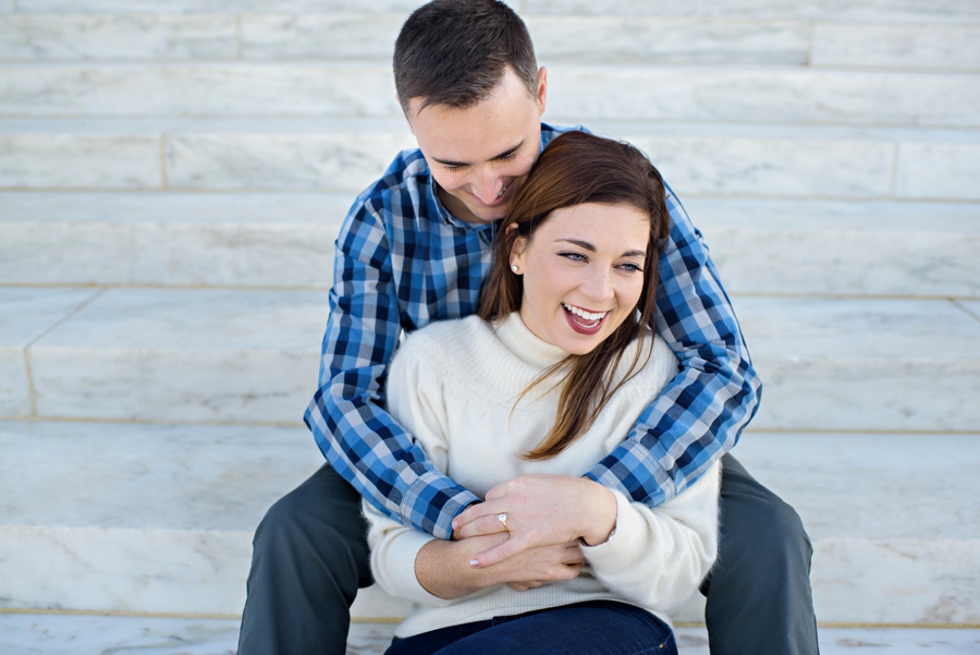 A Navy couple in love on the steps of the lincoln memorial in DC.